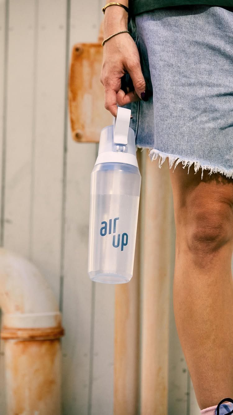 38 Gift Ideas for 13th Birthday in 2026, From Snoopy to LEGO 16 Air Up water bottle held by a person wearing a denim skirt