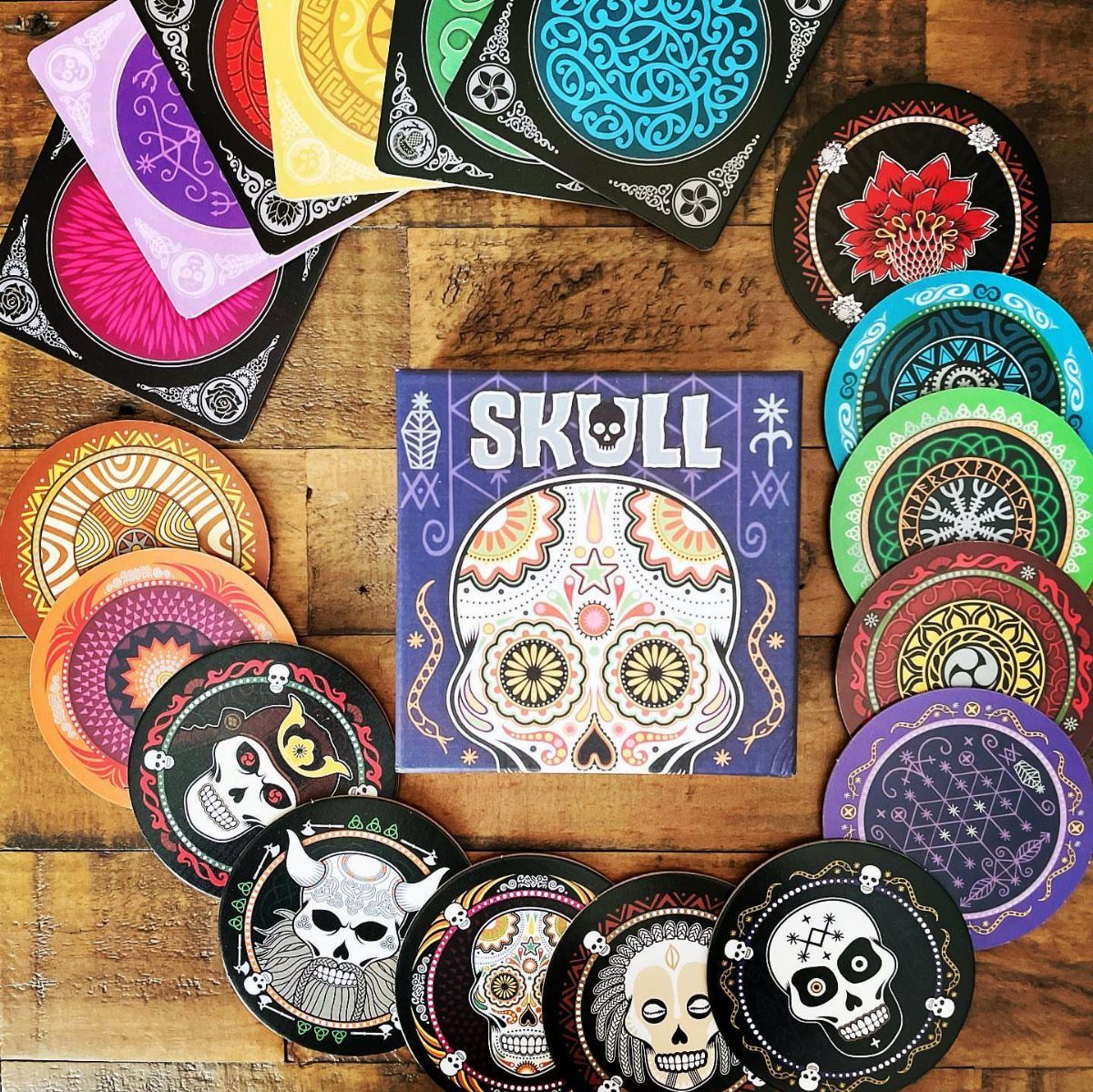 38 Gift Ideas for 13th Birthday in 2026, From Snoopy to LEGO 18 Skull board game box and circular coasters with colorful skull designs on wood.