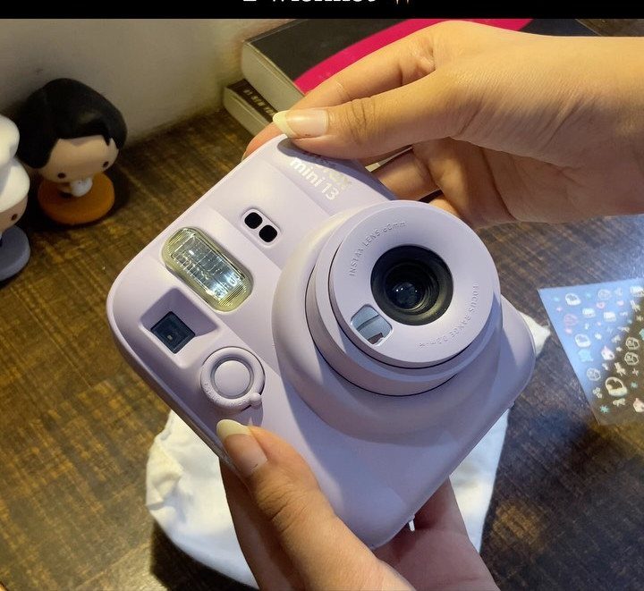 38 Gift Ideas for 13th Birthday in 2026, From Snoopy to LEGO 2 Light purple Fujifilm Instax Mini 13 instant camera held by two hands.