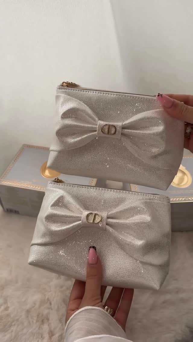 38 Gift Ideas for 13th Birthday in 2026, From Snoopy to LEGO 28 Two white glittery makeup bags with large bows held by a person's hands.