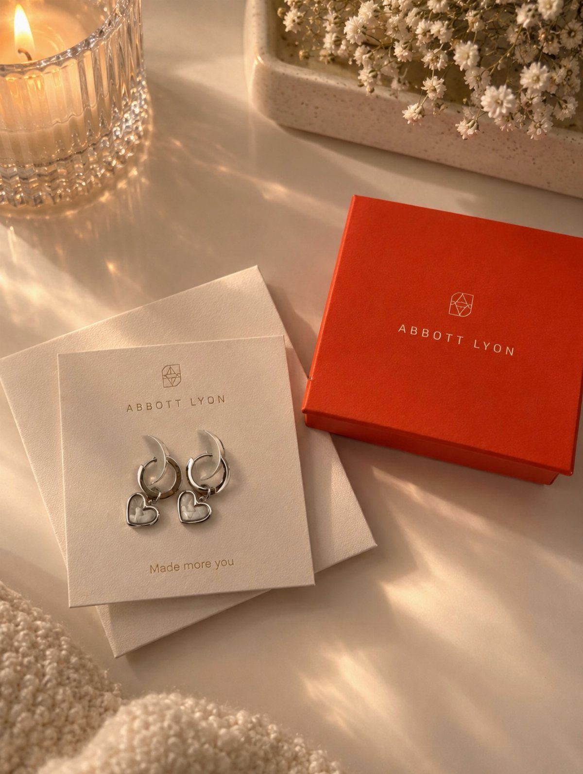 38 Gift Ideas for 13th Birthday in 2026, From Snoopy to LEGO 25 Silver heart hoop earrings on a white card next to a red jewelry box.