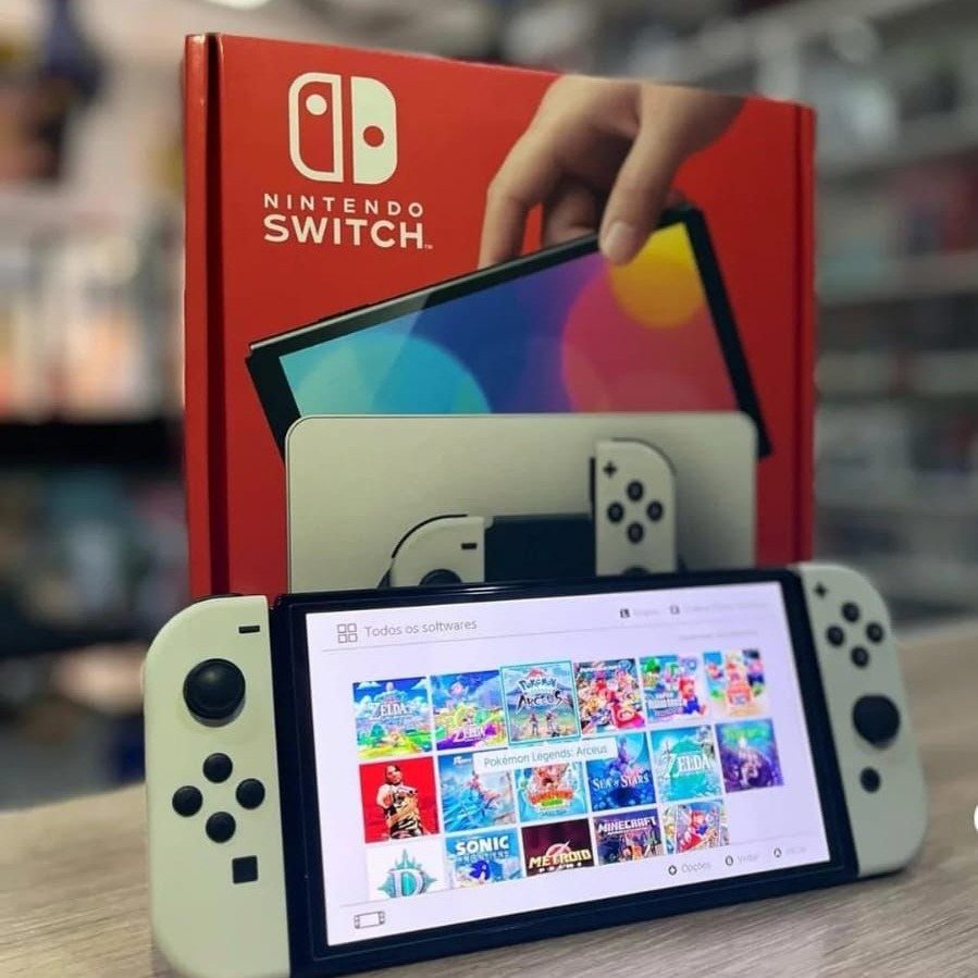 38 Gift Ideas for 13th Birthday in 2026, From Snoopy to LEGO 9 White Nintendo Switch console and red retail box on a light wooden surface.