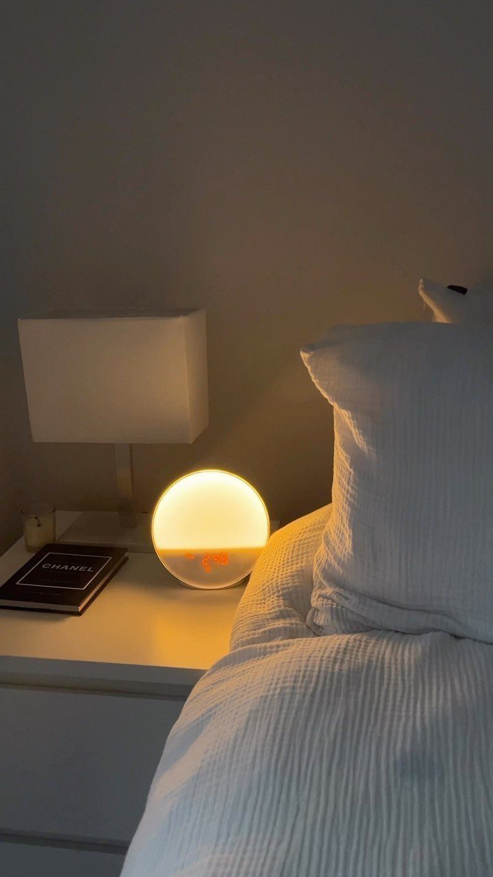 38 Gift Ideas for 13th Birthday in 2026, From Snoopy to LEGO 13 Spherical sunrise alarm clock glowing on a white bedside table next to a bed.