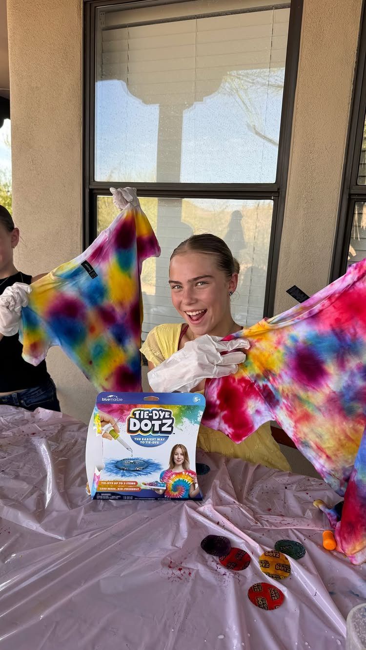 38 Gift Ideas for 13th Birthday in 2026, From Snoopy to LEGO 10 Teenage girl holding up colorful tie-dyed t-shirts next to a tie-dye kit.