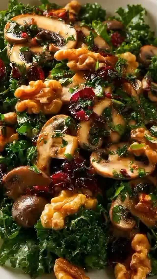 Kale and mushroom salad with walnuts and dried cranberries in a dark glaze.