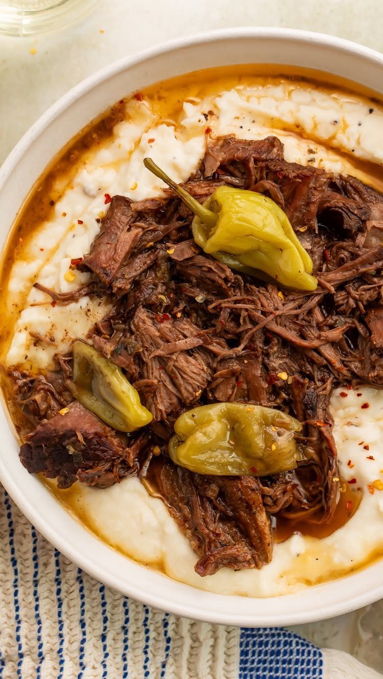 Shredded brown meat over creamy white puree topped with pickled yellow peppers.