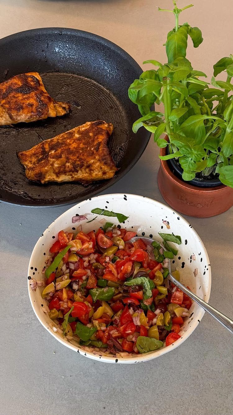 Toasted pita bread in a pan next to a bowl of fresh tomato salsa.