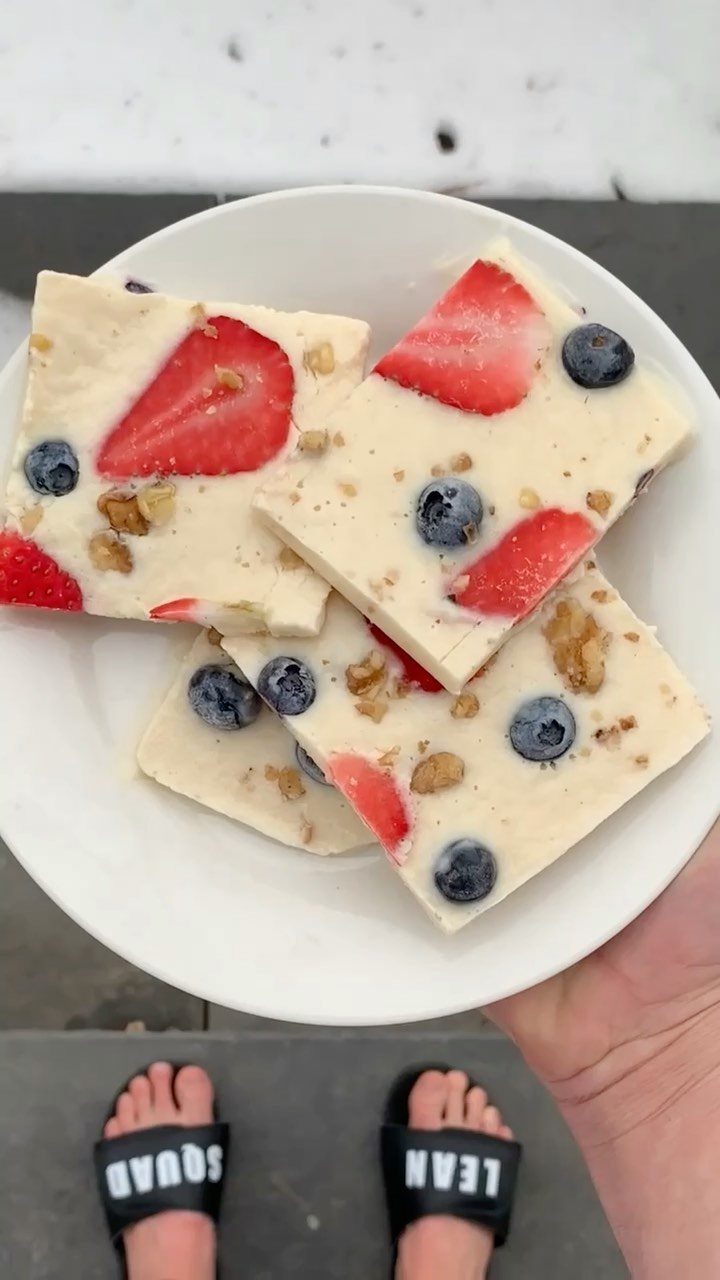 Frozen yogurt bark with strawberries, blueberries, and walnuts in a white bowl