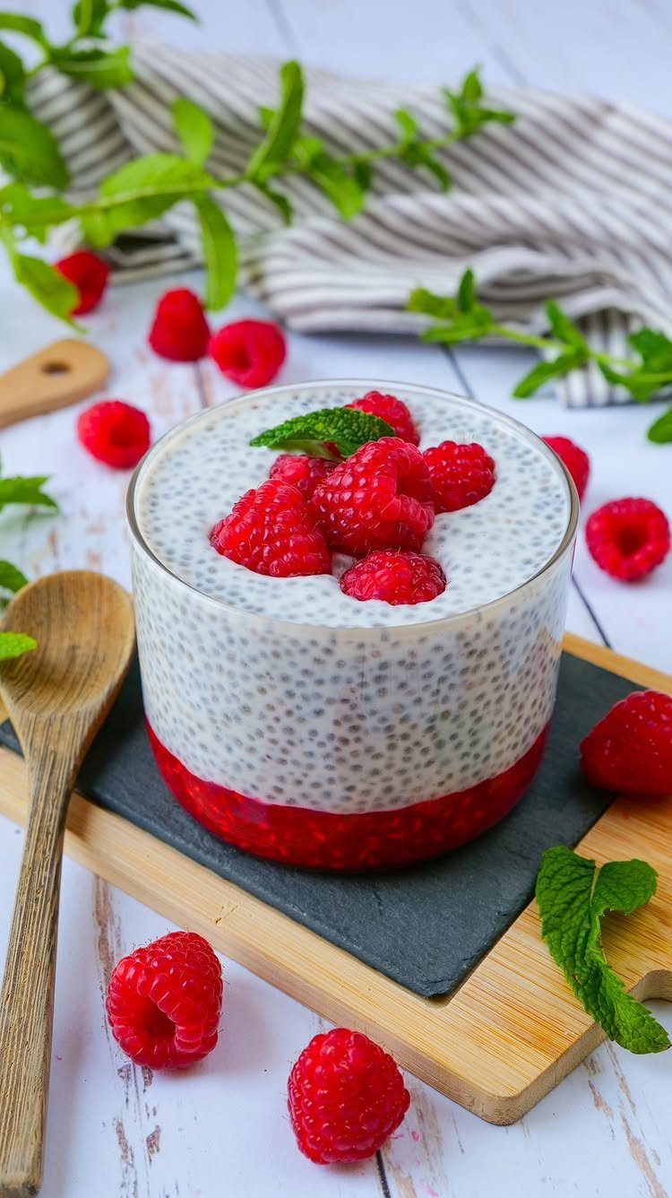 21 Healthy Mini Snacks for Lunchboxes, Parties and Busy Days 13 Chia seed pudding with fresh raspberries and mint in a glass jar.