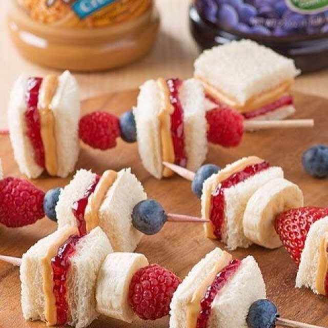 PB&J sandwich bites skewered with fresh raspberries, blueberries, and banana slices.