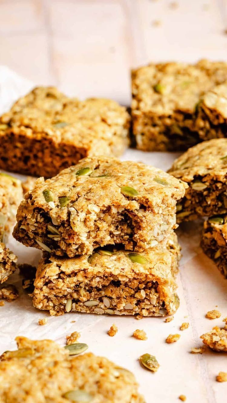 16 Morning Healthy Breakfast Ideas, From Egg Bites to Oats 15 Homemade energy bars with oats and seeds stacked on a light surface.