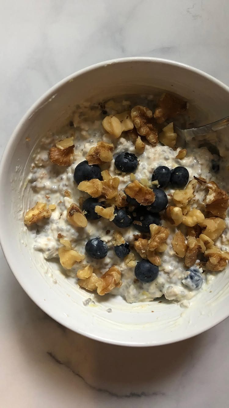 16 Morning Healthy Breakfast Ideas, From Egg Bites to Oats 12 Creamy oats topped with blueberries and walnuts in a white bowl on marble.
