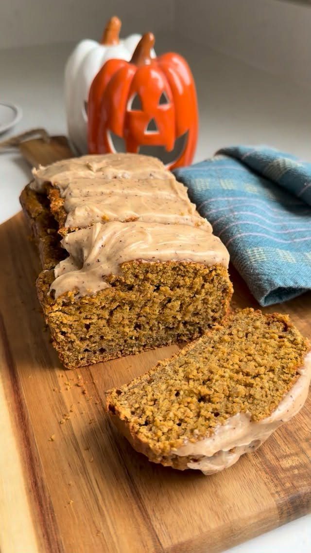 16 Morning Healthy Breakfast Ideas, From Egg Bites to Oats 11 Sliced pumpkin bread with frosting on a wooden board next to decorative pumpkins.