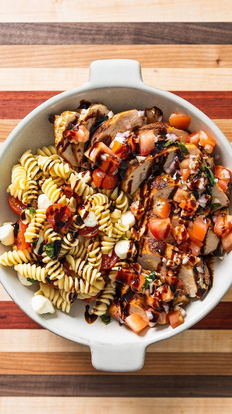 Grilled chicken and rotini pasta with mozzarella, tomatoes, basil, and balsamic glaze.