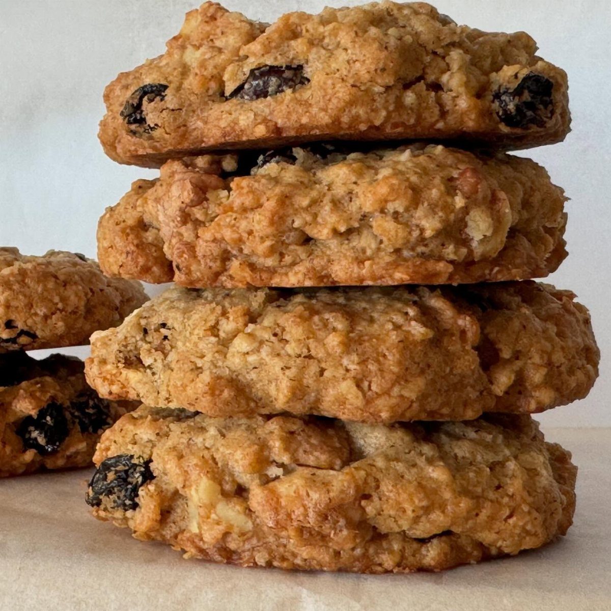 26 Oats Recipes for Snacks, from Energy Bites to Oat Crackers 12 Stack of thick golden-brown oatmeal cookies with chocolate chips on parchment paper.