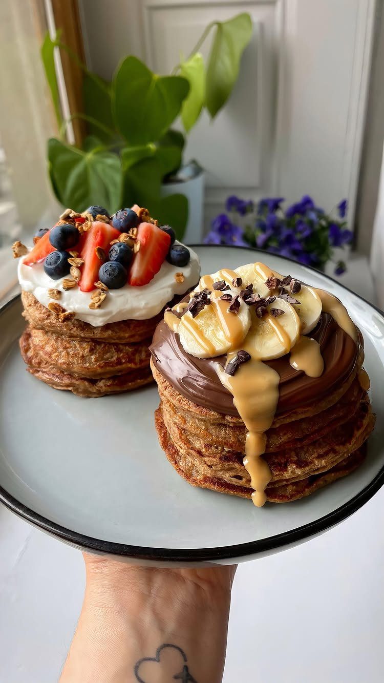 26 Oats Recipes for Snacks, from Energy Bites to Oat Crackers 20 Two stacks of oat pancakes topped with fresh berries and chocolate peanut butter bananas.