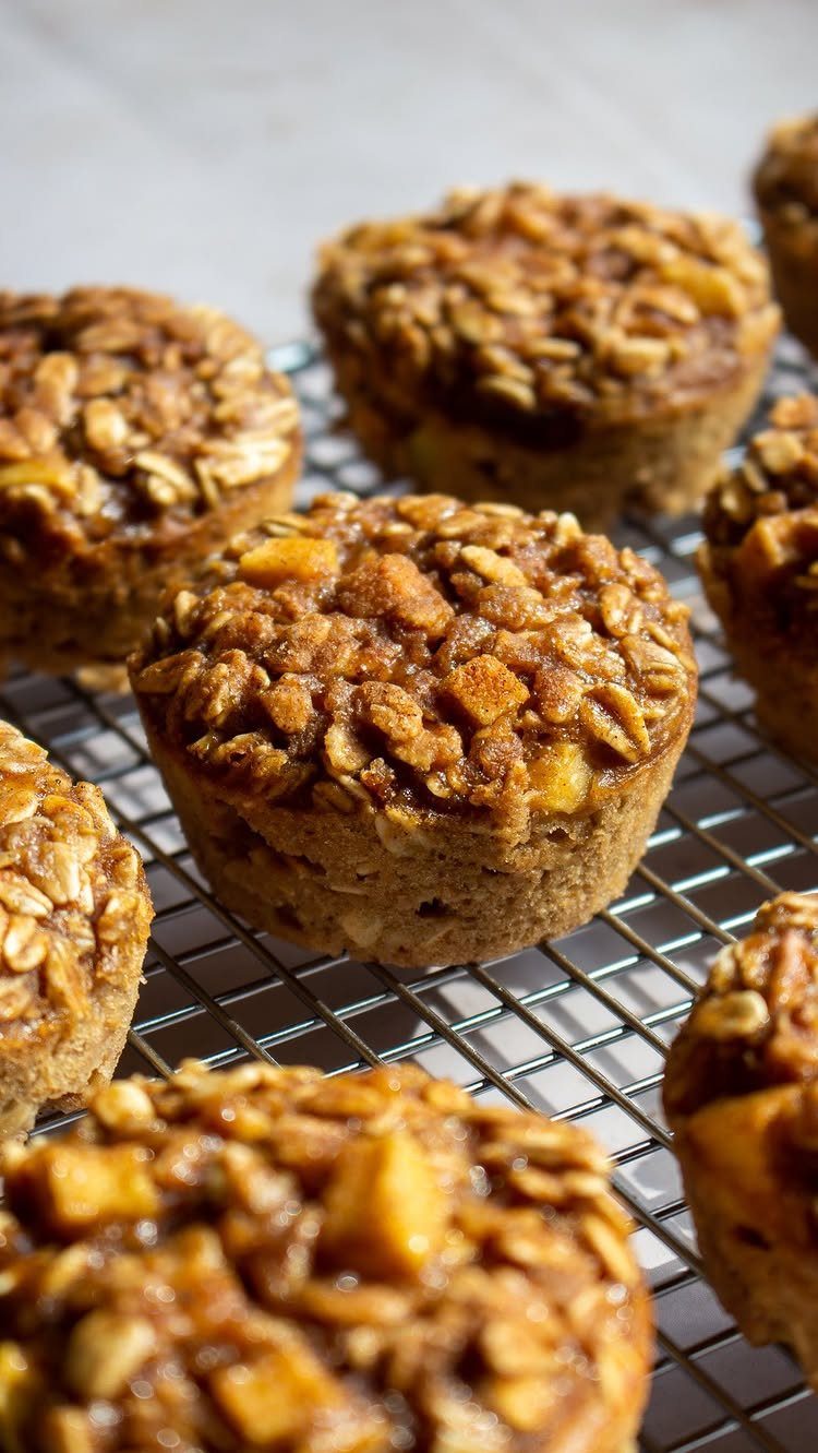 26 Oats Recipes for Snacks, from Energy Bites to Oat Crackers 6 Oatmeal muffins with oat toppings cooling on a metal wire rack.