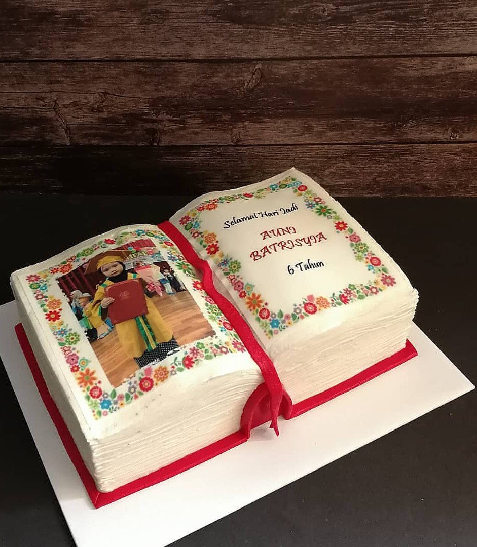 13 Open Book Cakes, from Fairytale Pages to Library Shelves 2 Open book cake with white pages, red cover, and a girl's portrait.