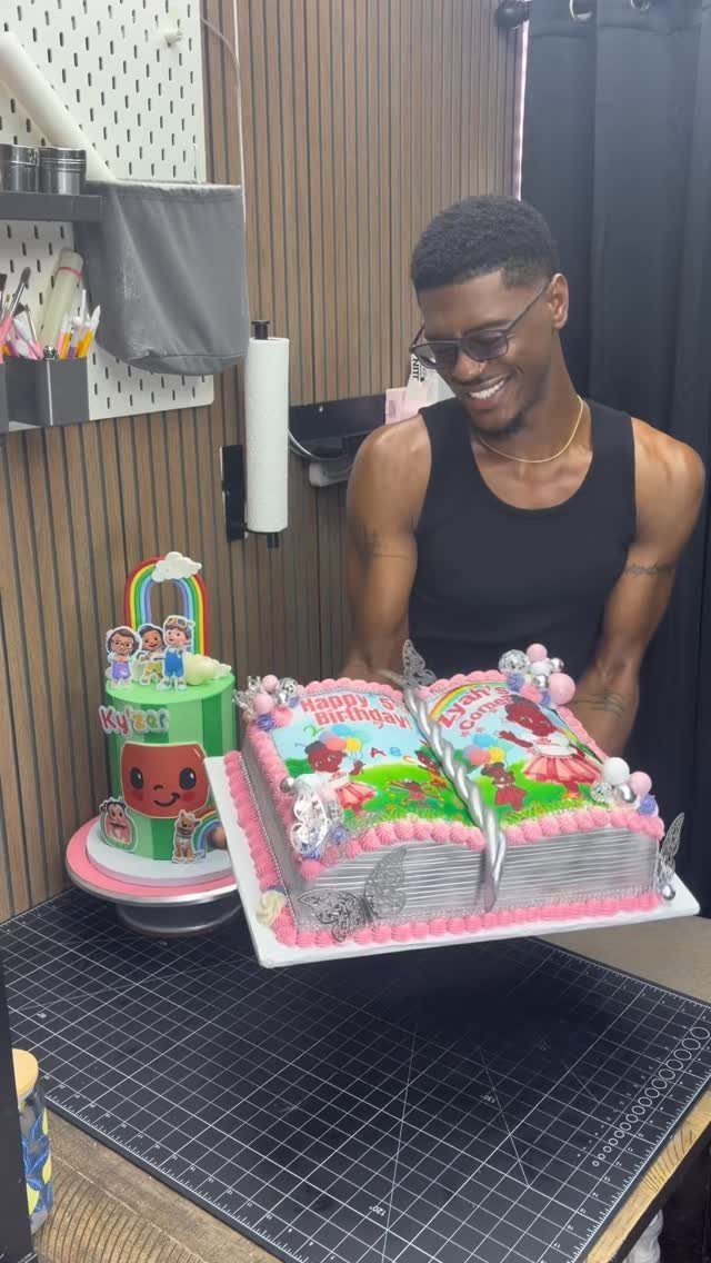 13 Open Book Cakes, from Fairytale Pages to Library Shelves 14 Man standing behind a cake shaped like an open book with pink frosting.