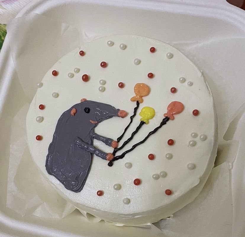 Rat Birthday Cake: 12 Ideas for Pet Rats, Pirates and Chefs 5 Grey icing rat holding three colorful balloons on a small white round cake