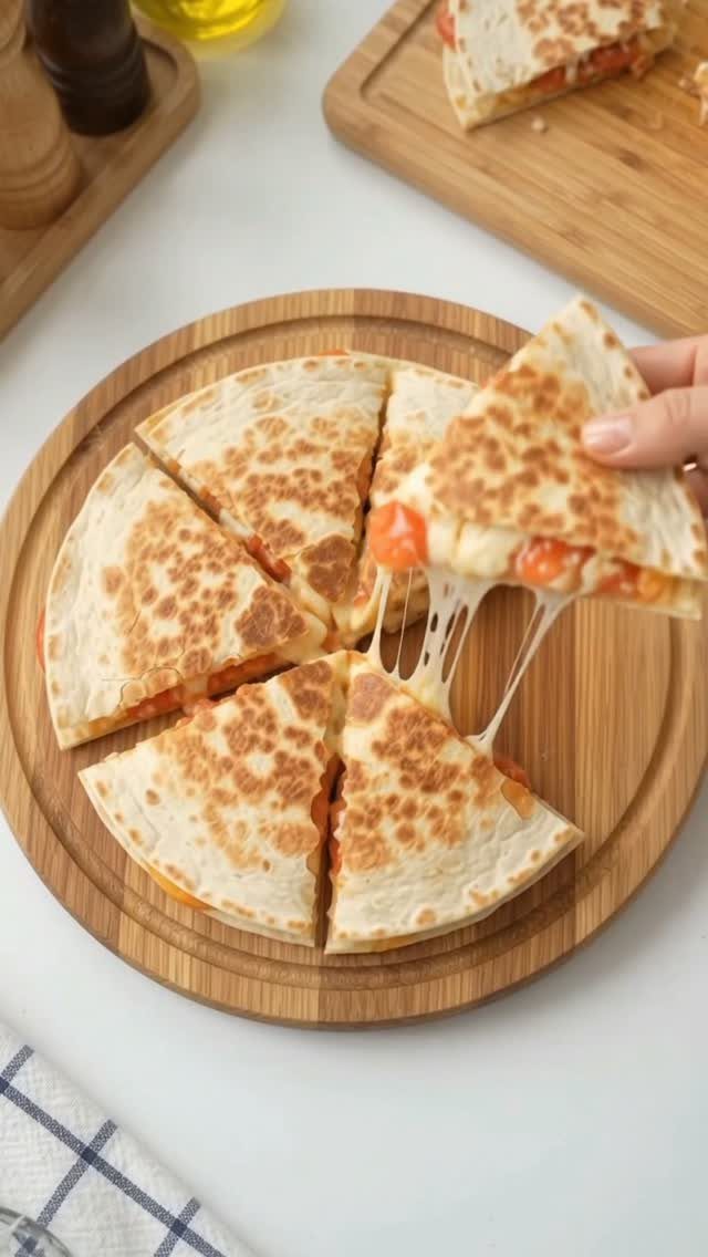 32 Ideas on What to Serve for Breakfast, From Eggs to Scones 32 Toasted breakfast quesadillas with melted cheese and vegetables on a wooden board.