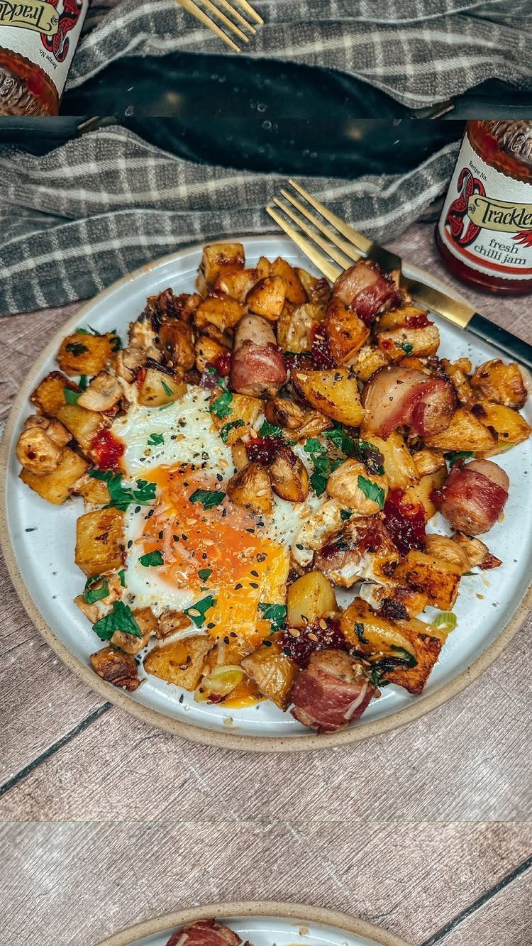 32 Ideas on What to Serve for Breakfast, From Eggs to Scones 5 Roasted breakfast potatoes with fried eggs and bacon-wrapped bites on a white plate.